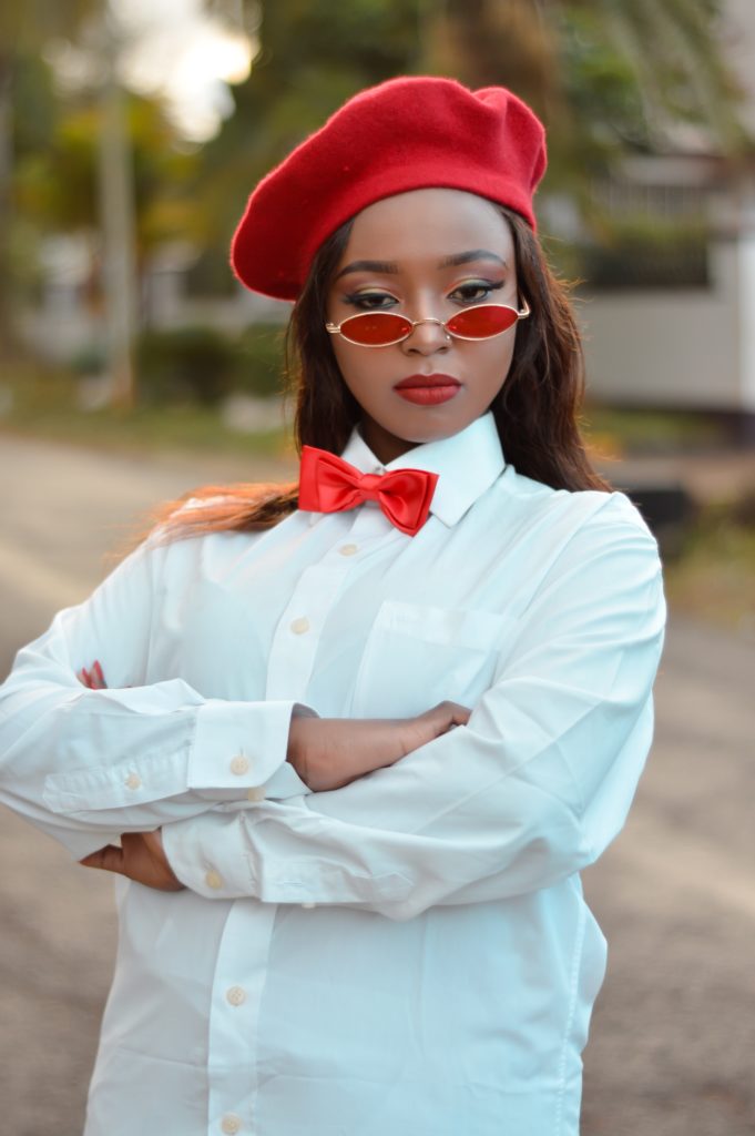 woman wearing white dress shirt and red cap